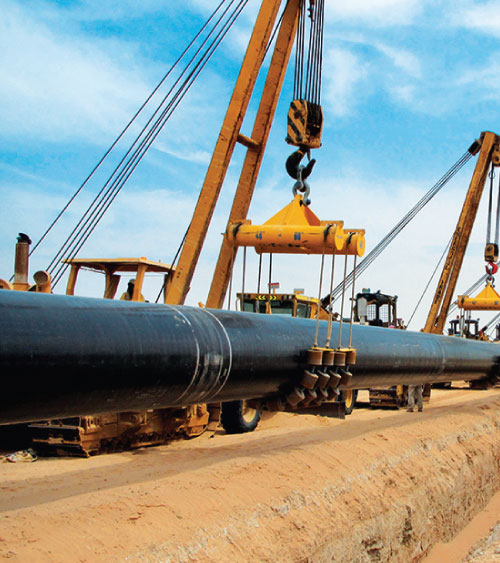 Pipeline section being lifted into place by cranes
